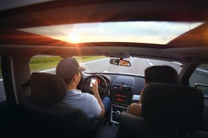 Driving on a highway at sunset