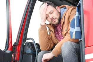 Sleepy truck driver in his rig