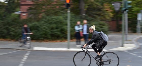 woman riding bicycle down the street